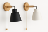Two wall-mounted lamps with wooden brackets and pull chains on a white background.