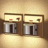 Two wall-mounted light switches on a textured wall with warm lighting.
