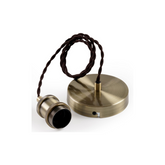 Brass-colored ceiling light fixture with cord on a white background