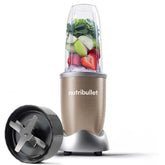 Nutribullet blender with fruits inside on a white background