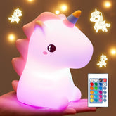 Unicorn-shaped night light with remote control on a brown background