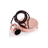 Rose gold pendant light with black cord on a white background