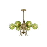 Chandelier with green glass shades and gold metal accents on a white background