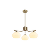 Modern pendant light with three glass shades on a white background