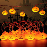 Halloween-themed string lights with pumpkin design against a dark background