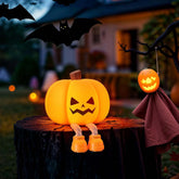 Halloween-themed decoration with a jack-o'-lantern on a stump and a ghost figure, set against a blurred outdoor background.