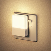 Wall-mounted light fixture with a switch on a beige wall
