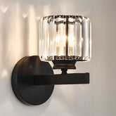 Wall-mounted light fixture with crystal glass shade on a neutral background