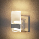 Wall-mounted night light fixture on a textured wall