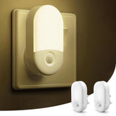Wall-mounted night light with two additional light bulbs on a dark background