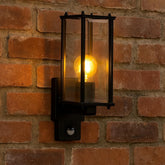 Wall-mounted outdoor light fixture on a brick wall