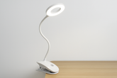 White LED desk lamp with flexible neck on a wooden surface against a light gray background