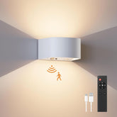 Modern wall light fixture with remote control and cable on a neutral background