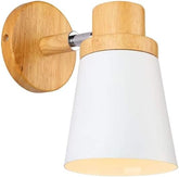 Wooden sconce light used as a bedside lamp for a warm ambiance