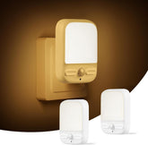 Yellow night light fixture with two white ones on a brown background