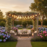 Outdoor garden setting with a wooden pergola, seating area, and colorful flowers.