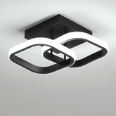 Modern ceiling light fixture with black and white design on a neutral background