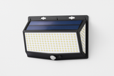 Solar-powered LED wall light on a white background