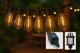 String of illuminated light bulbs with connectors inset on a blurred outdoor background
