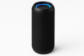 Black smart speaker with a blue light on a white background