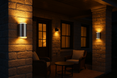 Dark room with stone walls, chairs, and wall-mounted lights.