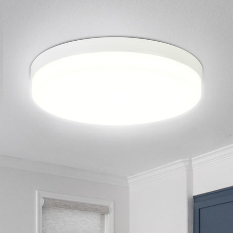 Close-up of the sleek round ceiling light with soft daylight glow

