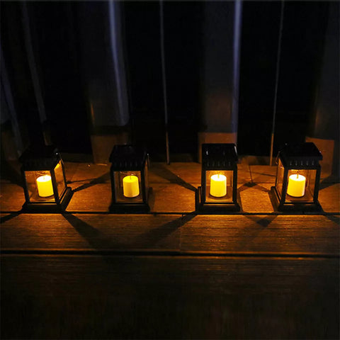 Lanterns glowing at dusk in a garden setting

