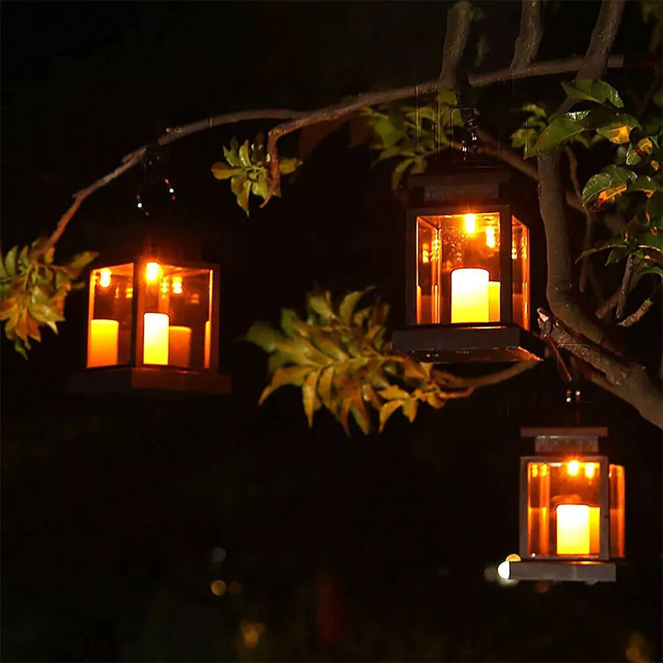 Hanging lanterns illuminating a patio umbrella at night

