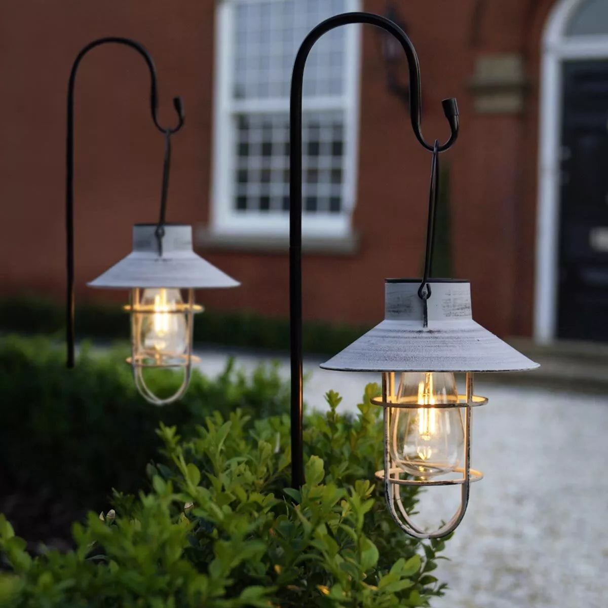 Solar-powered garden lantern with retro filament LED design

