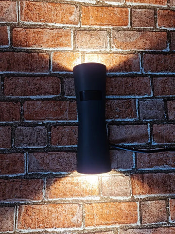 LED wall light with motion sensor detecting movement in a garden


