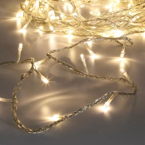 Close-up of warm white LED lights on clear cable

