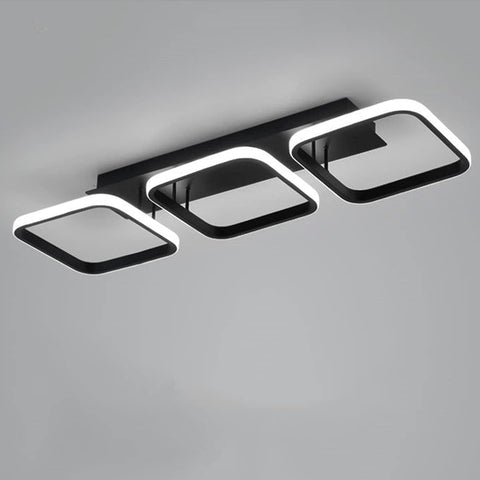 Modern ceiling light fixture with three square panels on a gray background