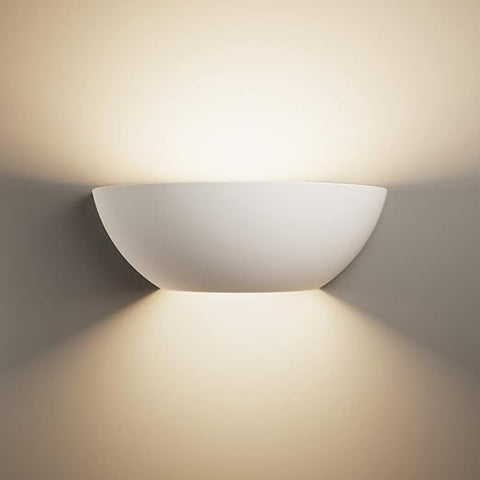 Half moon up & down wall light sconce with soft ambient lighting in a modern bedroom.

