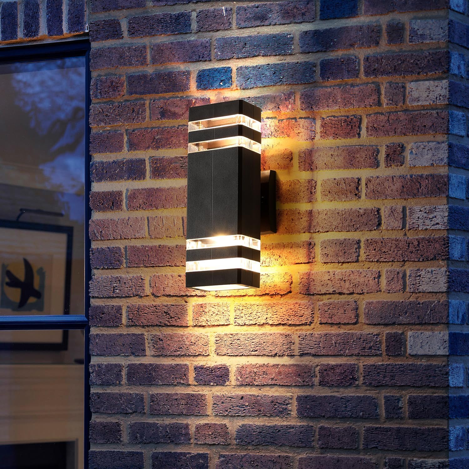 Wall-mounted outdoor light fixture on a brick wall