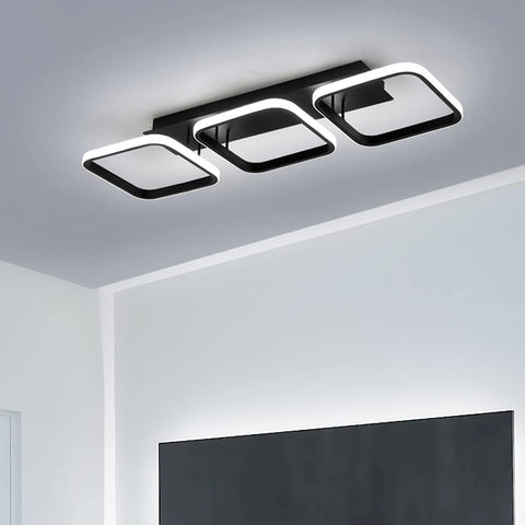 Modern ceiling light fixture in a room with a television.