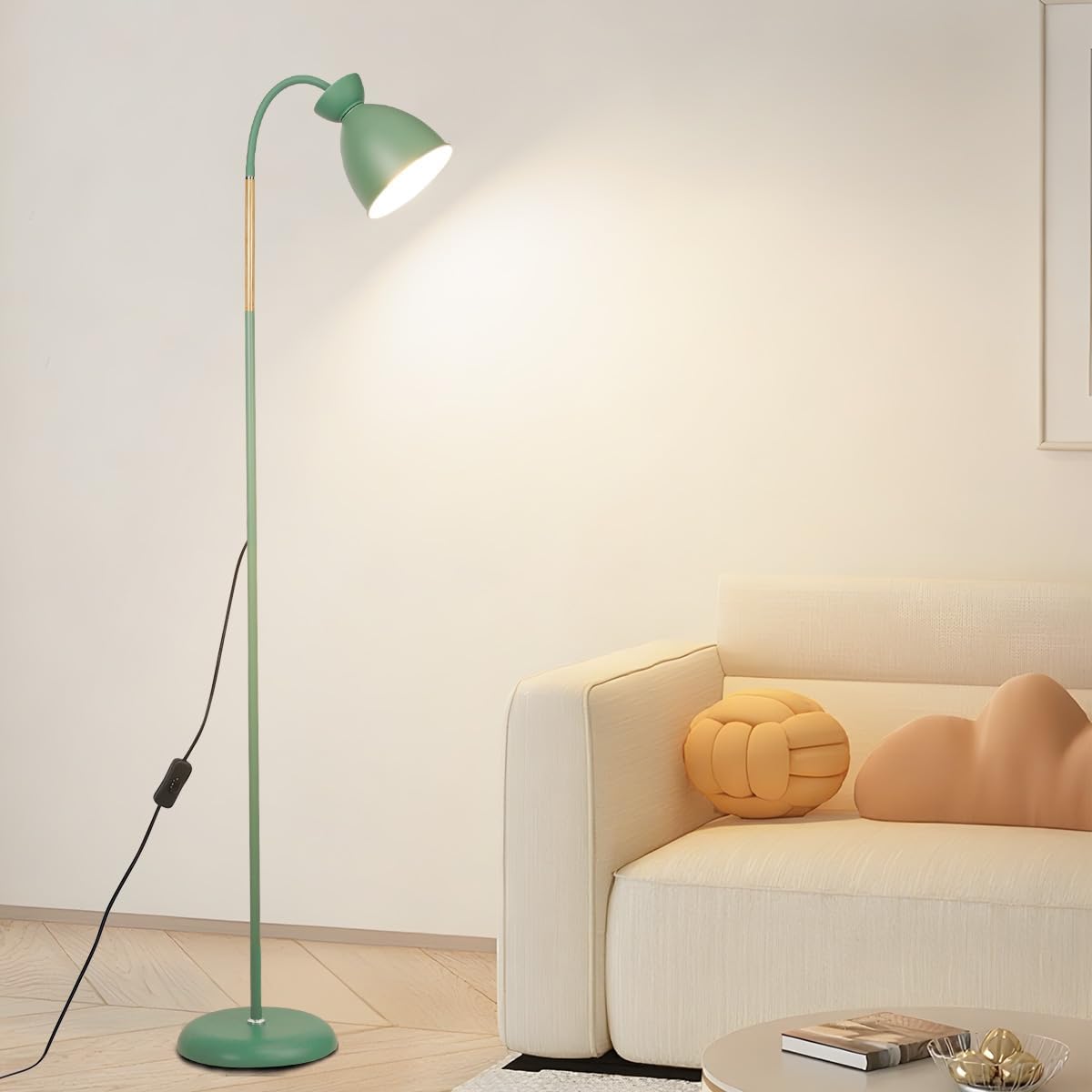 Green floor lamp in a living room with a beige sofa and decorative pillows.
