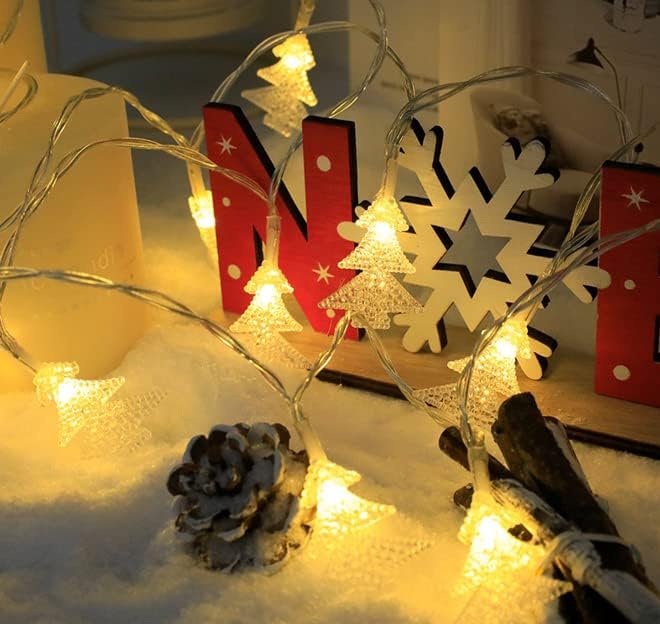 Decorative string lights with Christmas-themed decorations on a table.