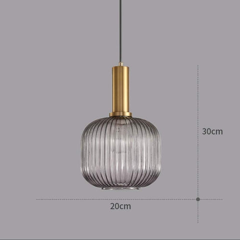 Pendant light with ribbed glass shade and gold fixture on a gray background