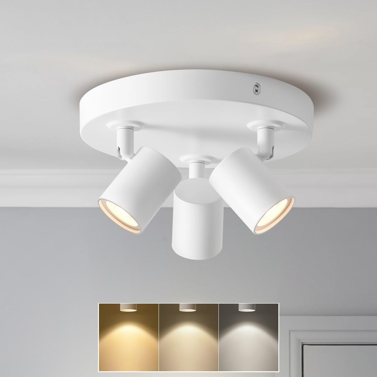 White ceiling light fixture with three adjustable lights on a gray ceiling.