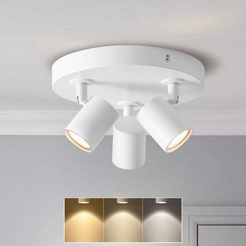 White ceiling light fixture with three adjustable lights on a gray ceiling.