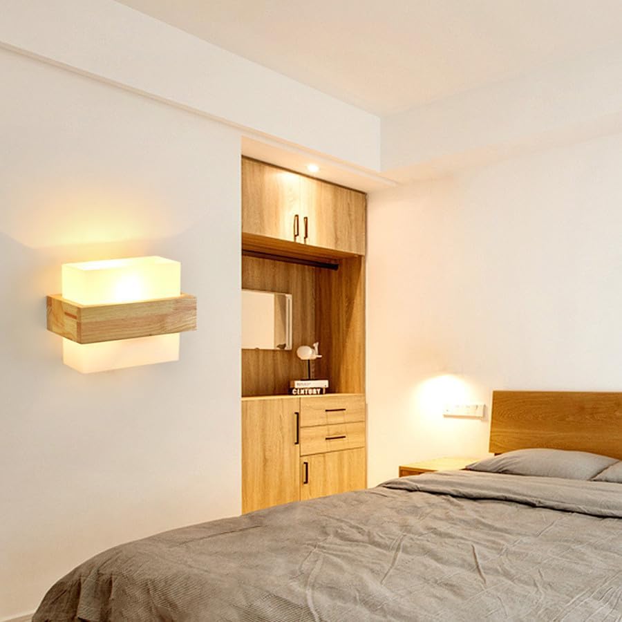 Modern bedroom with wooden wardrobe, bed, and wall lights.