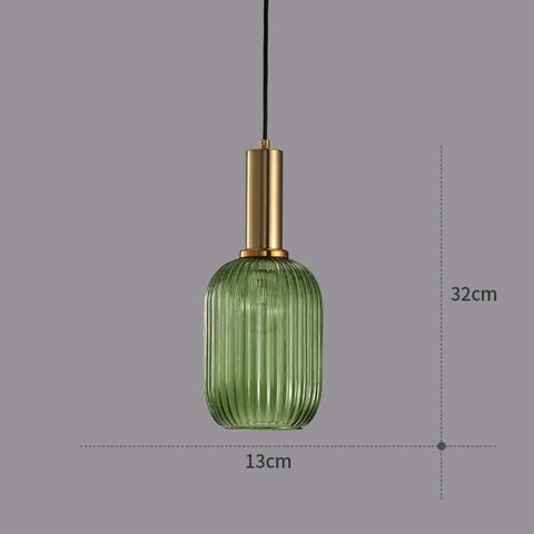 Green glass pendant light with gold fixture on a gray background