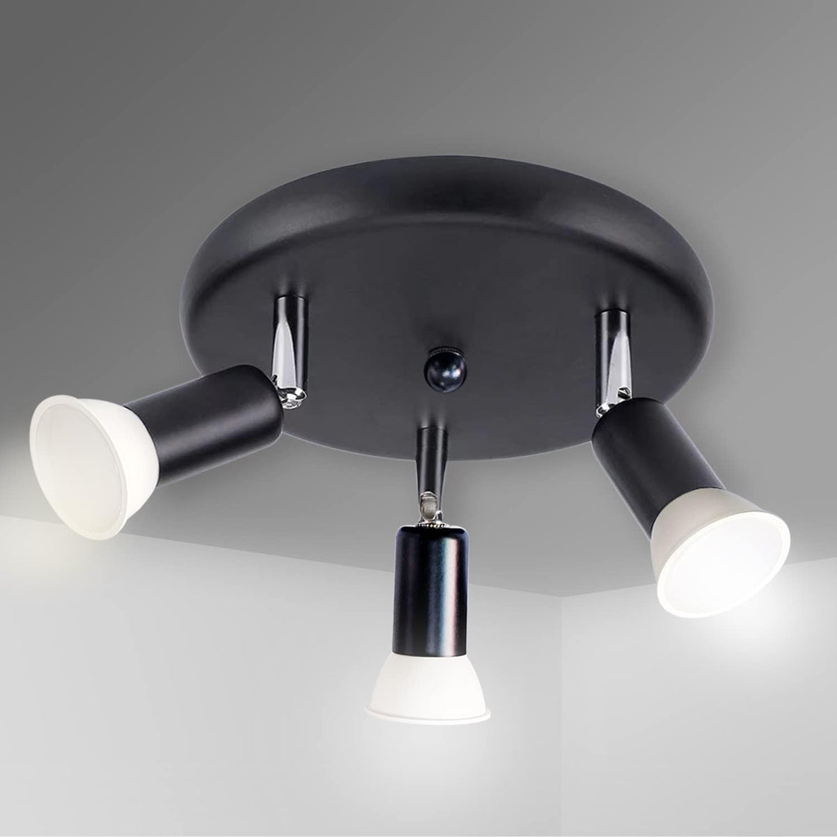 Black ceiling light fixture with three white light bulbs on a gray background