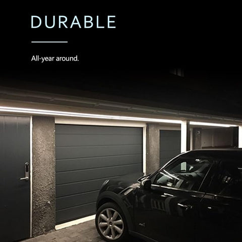 Garage with a car parked in front of a closed garage door, with text 'Durable All-year around' on a black background.