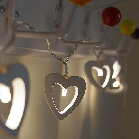 Warm white LED heart lights enhancing a cozy living room ambiance.

