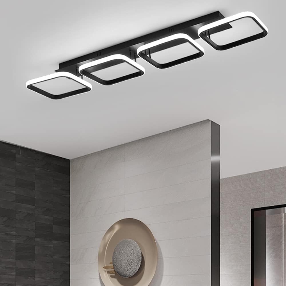 Modern ceiling light fixture in a room with a mirror and wall decor.
