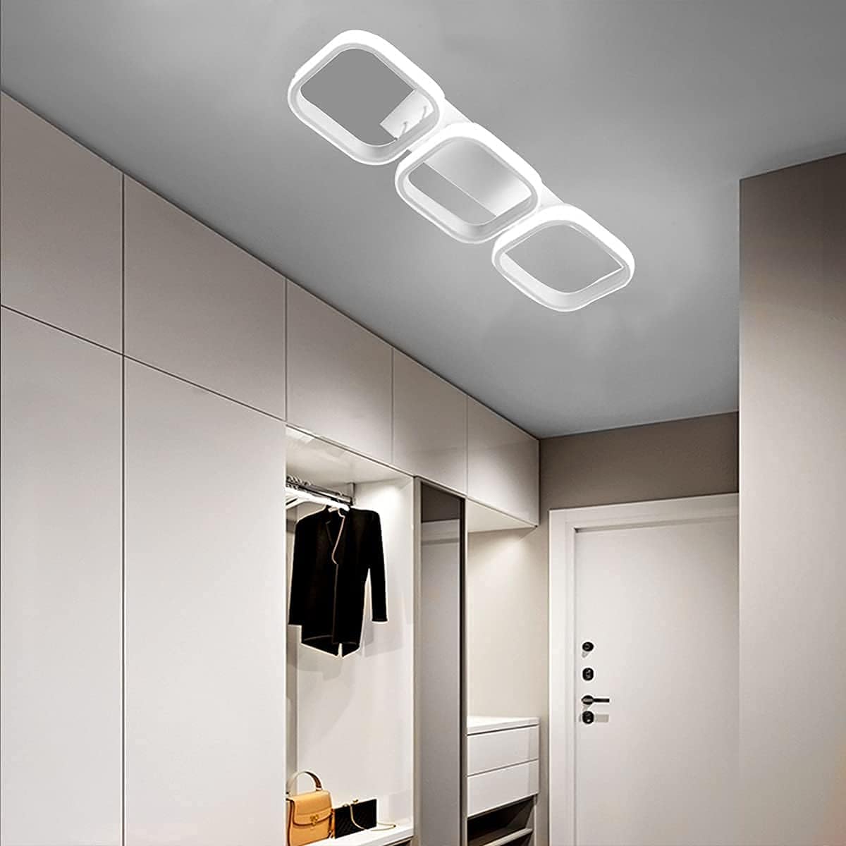 Ceiling light fixture in a modern interior setting with wardrobe and mirror.