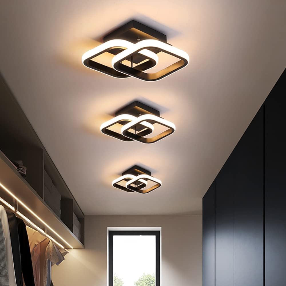 Modern ceiling lights in a room with neutral walls and a window.