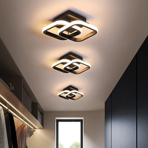 Modern ceiling lights in a room with neutral walls and a window.