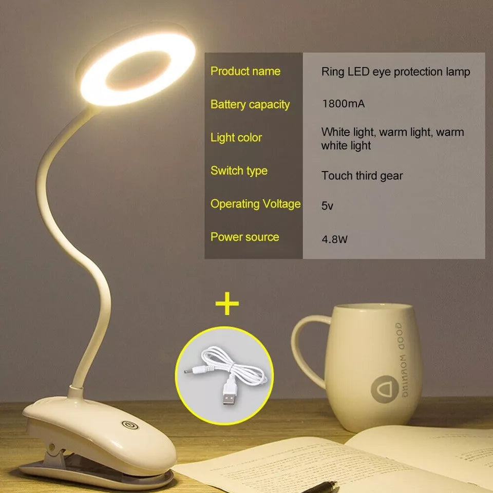 Light clipped to a bedframe with the gooseneck extended.

